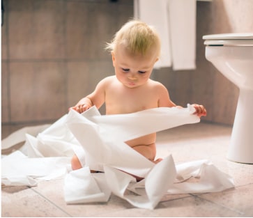 baby making a mess with toilet paper